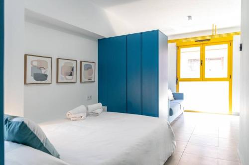 a bedroom with a large bed and a blue cabinet at Estudio moderno y acogedor en Madrid Rio nº6 in Madrid