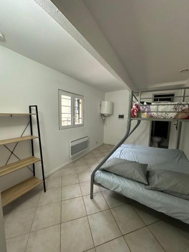 a bedroom with a bunk bed and a tiled floor at JAR04 in Le Blanc-Mesnil