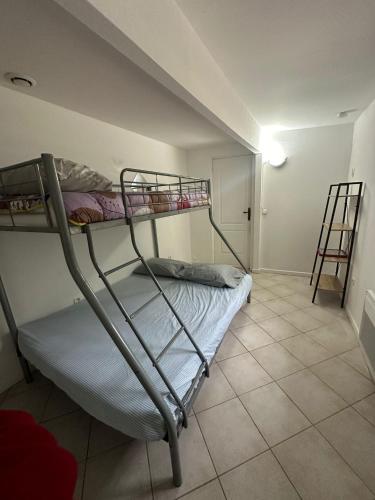 a bedroom with two bunk beds and a ladder at JAR04 in Le Blanc-Mesnil