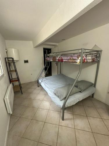 a bunk bed in a room with a ladder at JAR04 in Le Blanc-Mesnil