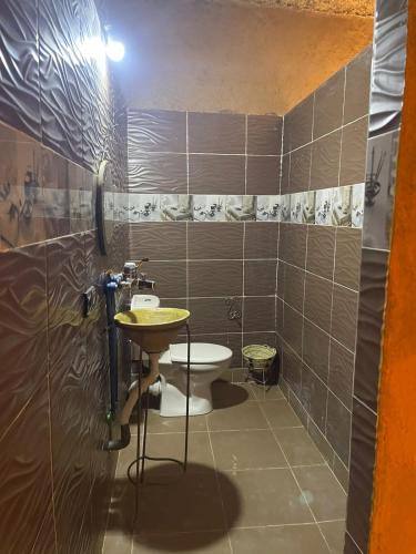 a bathroom with a sink and a toilet at GITE Take your time in Merzouga