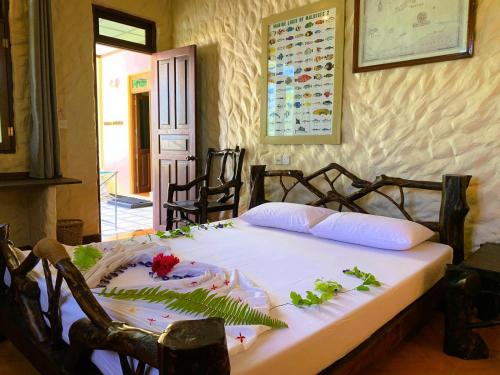 Un dormitorio con una cama con flores. en Villa Stella, Rinbudhoo en Dhaalu Atoll