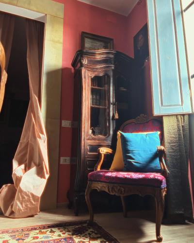 a chair with a blue pillow in a room at Art action room in Villanovafranca