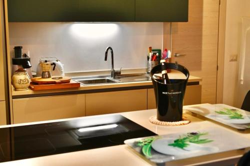a kitchen counter with a utensils in a cup on a counter at Wave Home 2 in Castel Gandolfo