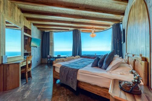 a bedroom with a large bed with a view of the ocean at Bay Lodge Boutique Hotel in Jounieh