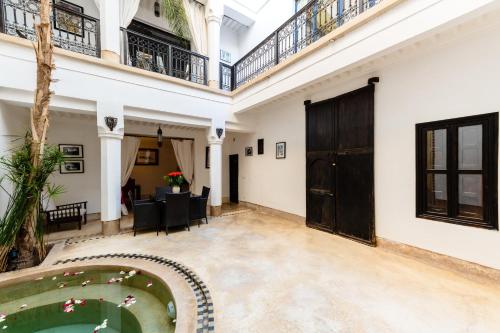 a courtyard with a pool in a house at Riad Rouge Gorge in Marrakesh