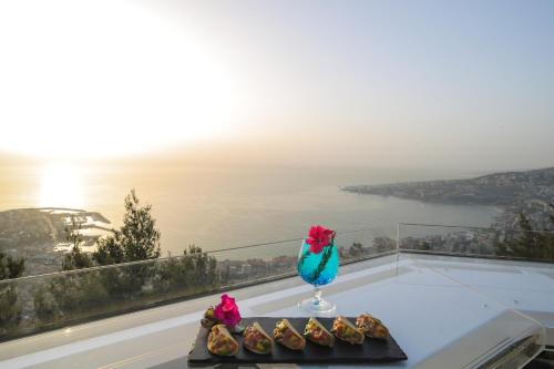 a vase on a table with some food on a balcony at Bay Lodge Boutique Hotel in Jounieh