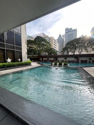 a swimming pool in the middle of a building at Spacious Luxury 3BR at the Heart of Makati in Manila
