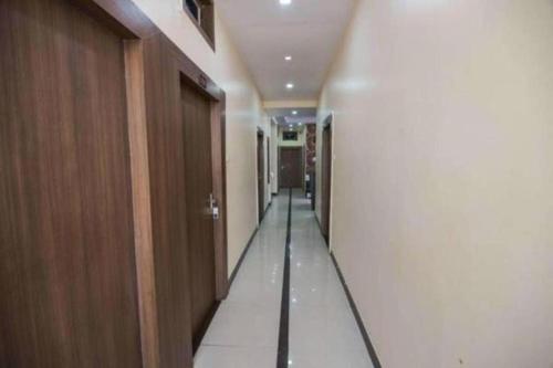 a hallway in a building with a long corridor at Hotel Swarat By BookingCare in Satna