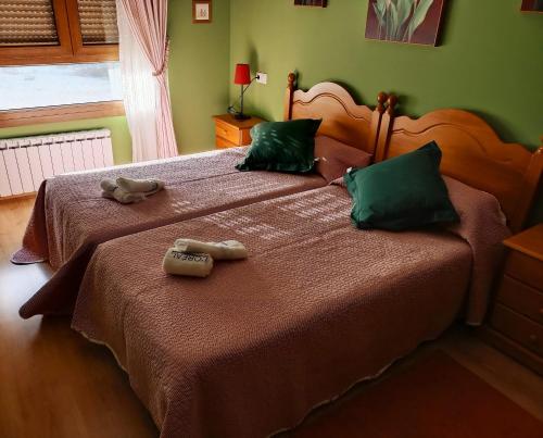Dos camas en un dormitorio con dos ositos de peluche. en 21A02 Coqueto apartamento en la nieve con garaje en Felechosa