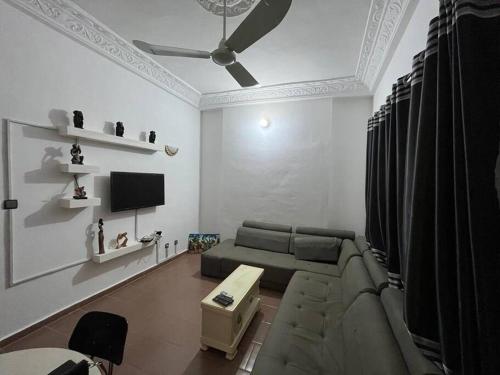 a living room with a couch and a tv at Appartement F2 Meublé in Cotonou