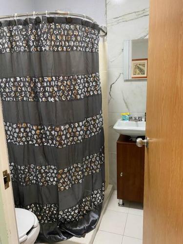 a bathroom with a shower curtain and a sink at Casa duplex aeropuerto/arena VFG in Guadalajara
