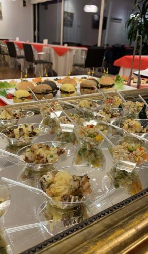 a buffet filled with different types of food in bowls at Schio Hotel in Schio