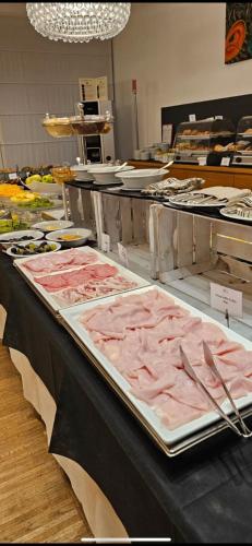 a buffet line with many different types of food at Schio Hotel in Schio
