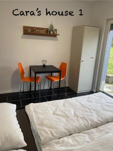 a bedroom with a bed and a table and chairs at Cara's house in Ljubljana