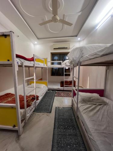 a room with two bunk beds and a ceiling at Hostel Go And Stay Jaisalmer in Jaisalmer