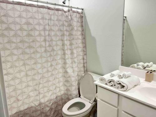 a bathroom with a toilet and a sink and a shower curtain at *Home away from home* 5 min away from Stadium in Phoenix