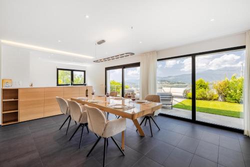 a dining room with a large wooden table and chairs at Villa Girandola with private, heated pool in Lugano