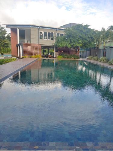 una gran piscina de agua frente a un edificio en Canterbury Residence Garden Apartment en Kahatuduwa