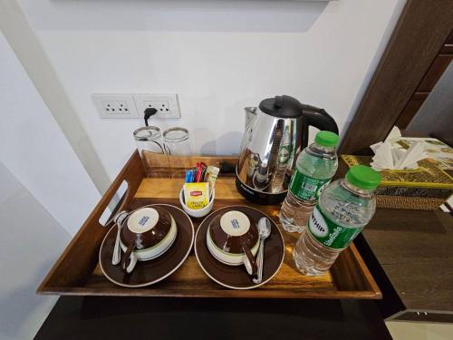 a tray with plates and water bottles on a table at Samui Green Hotel in Chaweng