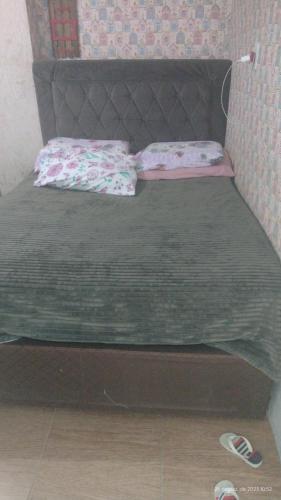 a bed with two pillows on it in a room at balneário Camboriú, disponível para carnaval in Balneário Camboriú