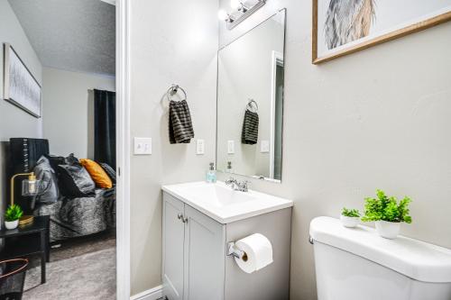 y baño con lavabo, aseo y espejo. en Spacious Utah Home 34 Mi to Salt Lake City, en Tooele