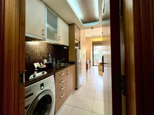 a kitchen with a washing machine and a sink at Karl s Single Room with Gym and Bar in Jounieh