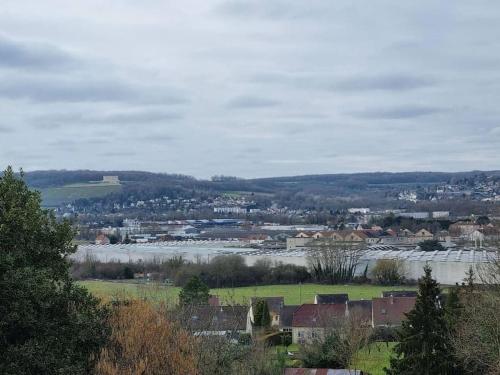 a view of a town with a river and a city at Cosy appartement proche Disneyland in Étampes-sur-Marne