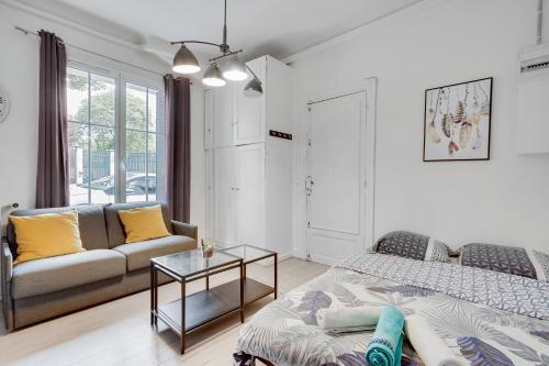 a living room with a couch and a bed at Smart apart in Paris in Vanves