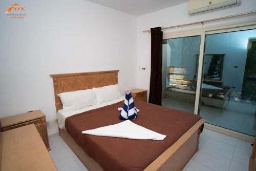 a bedroom with a bed with a blue and white bow at ELCAPTION RESORT in Hurghada
