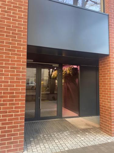 a brick building with a sign on the side of it at Apartamenty Wolności 6 self check-in 24h in Poznań