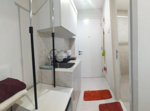a small bathroom with a shower and a sink at Astara Hotel Balikpapan in Balikpapan