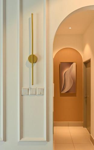 a hallway with an archway and a painting on the wall at Razak City Residence in Kuala Lumpur