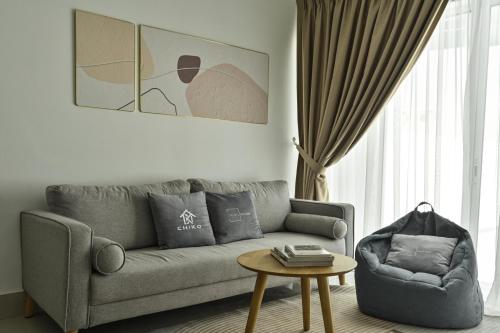 a living room with a couch and a table at Razak City Residence in Kuala Lumpur
