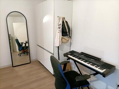 a dressing room with a piano and a mirror at Bahnhof in Bielefeld