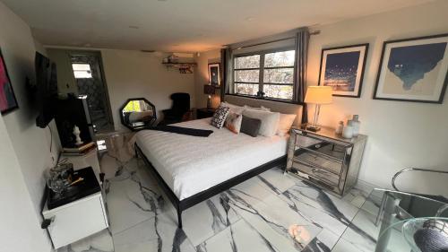 a bedroom with a bed and a television in it at Paradise Gardens-Wilton Manors- Male only in Fort Lauderdale