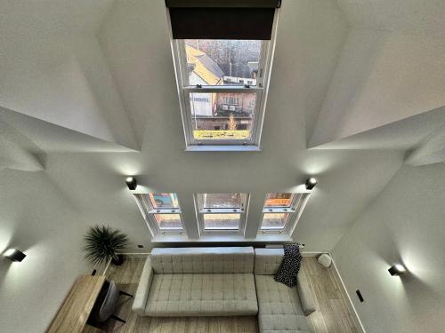 an overhead view of a staircase in a building with a window at Luxury Duplex City Centre Apartment in Leeds