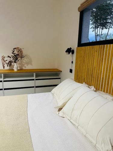 a bedroom with a white bed with a window at Casa Simona in Las Rabonas