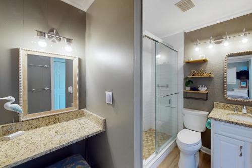 a bathroom with a shower and a toilet and a mirror at Sea Side Villas 171 in Hilton Head Island