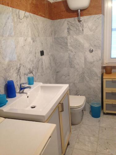 a bathroom with a sink and a toilet at Casa Nika in Sabaudia