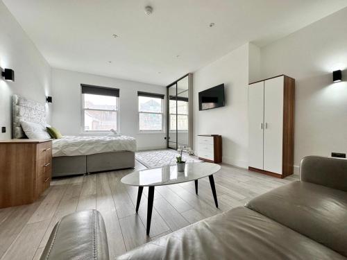a living room with a bed and a coffee table at Cute, Stylish 1 Bedroom Leeds City Apartment in Leeds