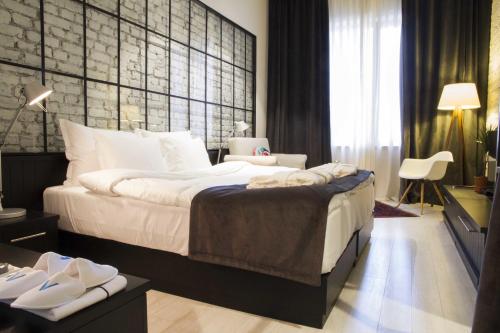 A bed or beds in a room at Magnova Studios