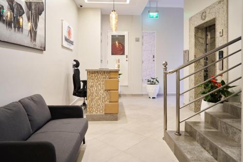 a living room with a couch and stairs at Westwood Residences in Arusha