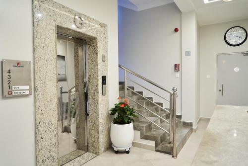 a lobby with a door with a plant in it at Westwood Residences in Arusha