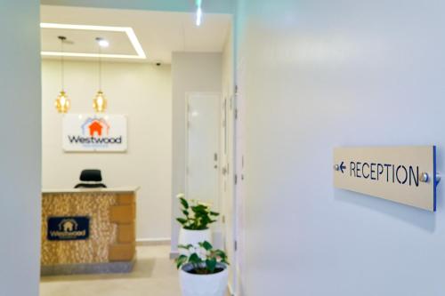 an entrance to an office with a sign that reads at reception at Westwood Residences in Arusha