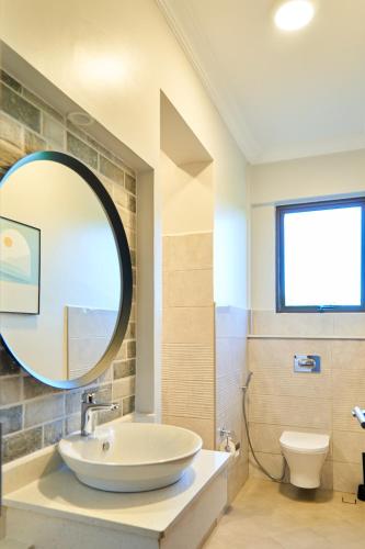 a bathroom with a sink and a mirror at Westwood Residences in Arusha