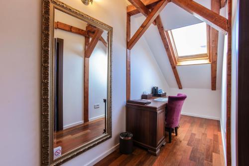 a mirror in a room with a vanity and a window at Villa 1927 in Belgrade