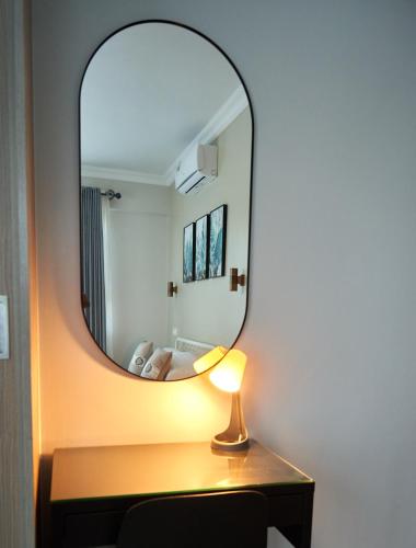 a mirror on a table with a lamp on it at Westwood Residences in Arusha