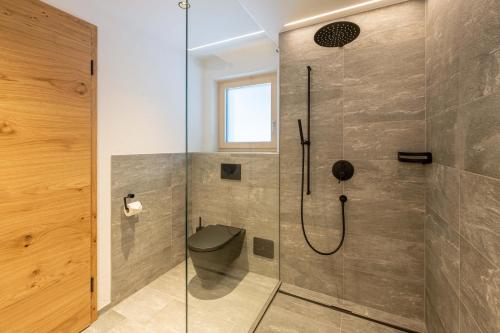 a bathroom with a shower with a toilet at Mountain Lodge in Grächen