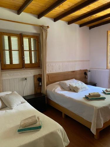 a bedroom with two beds with towels on them at La Foresta in Rincón del Pino